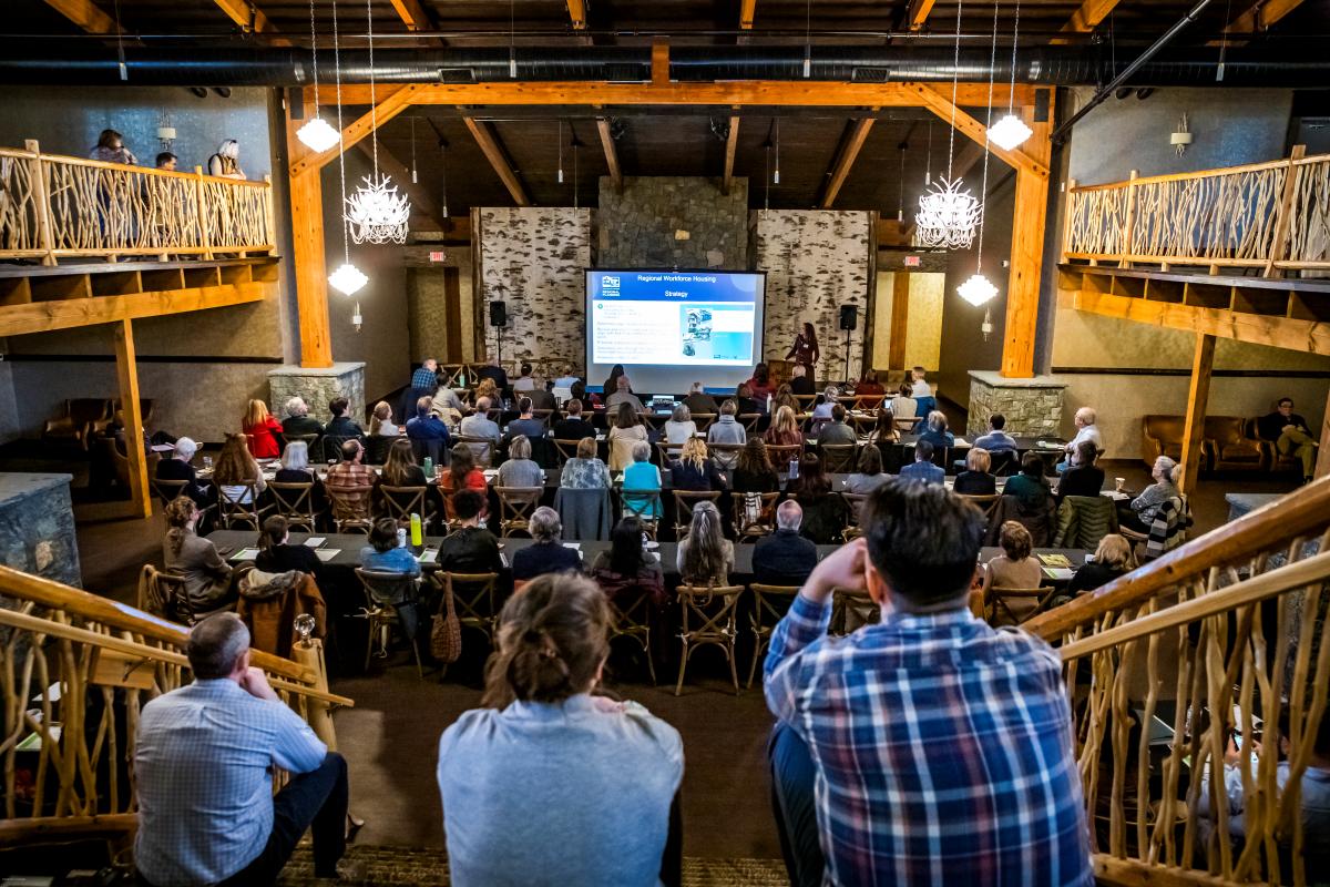 People sitting on steps watching a presentation