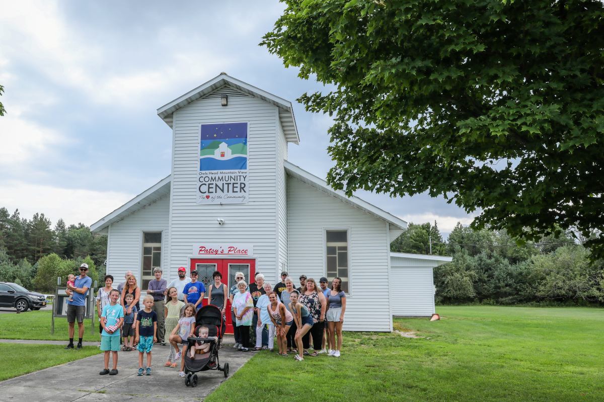 Community members stand in front of a new community center