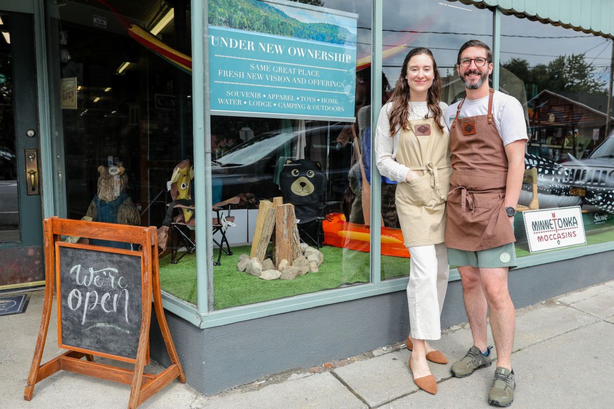 Woman and man stand in front of their new business