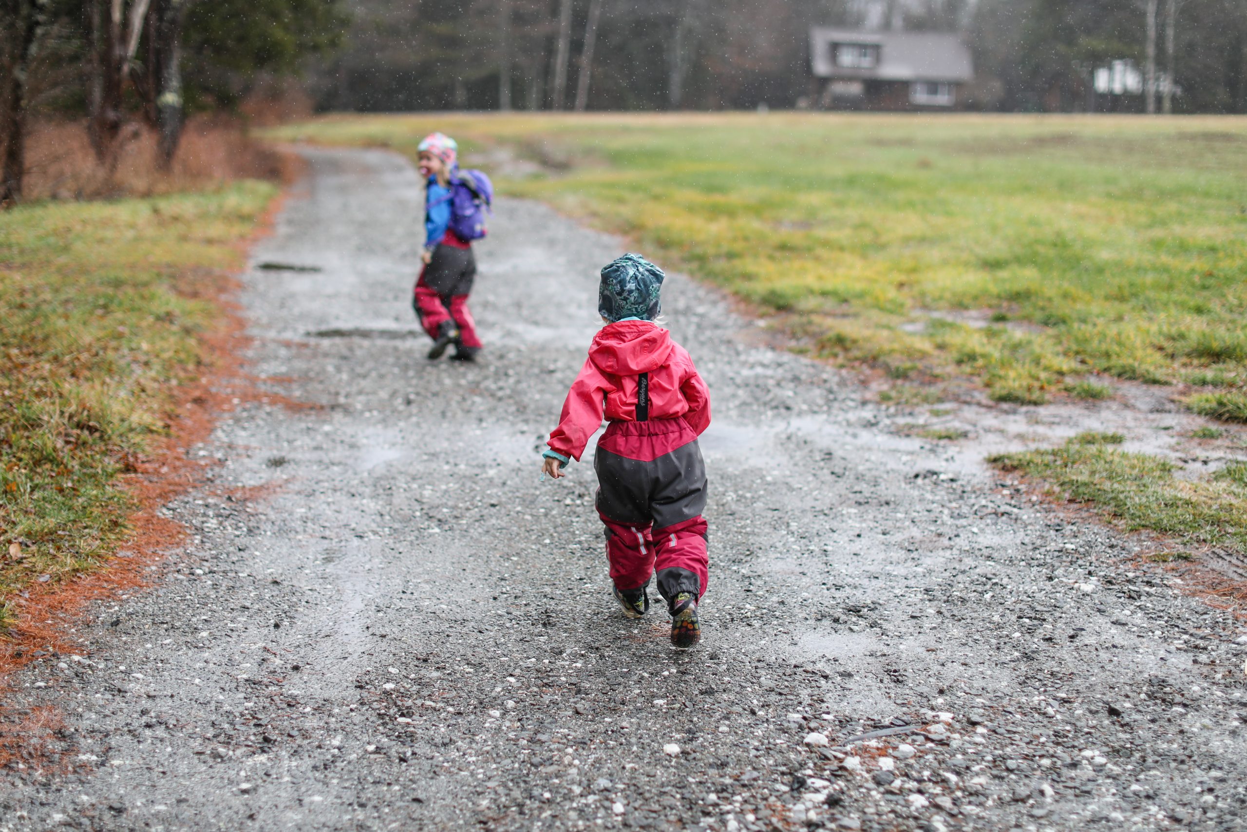 Kids running on dirt road in the rain