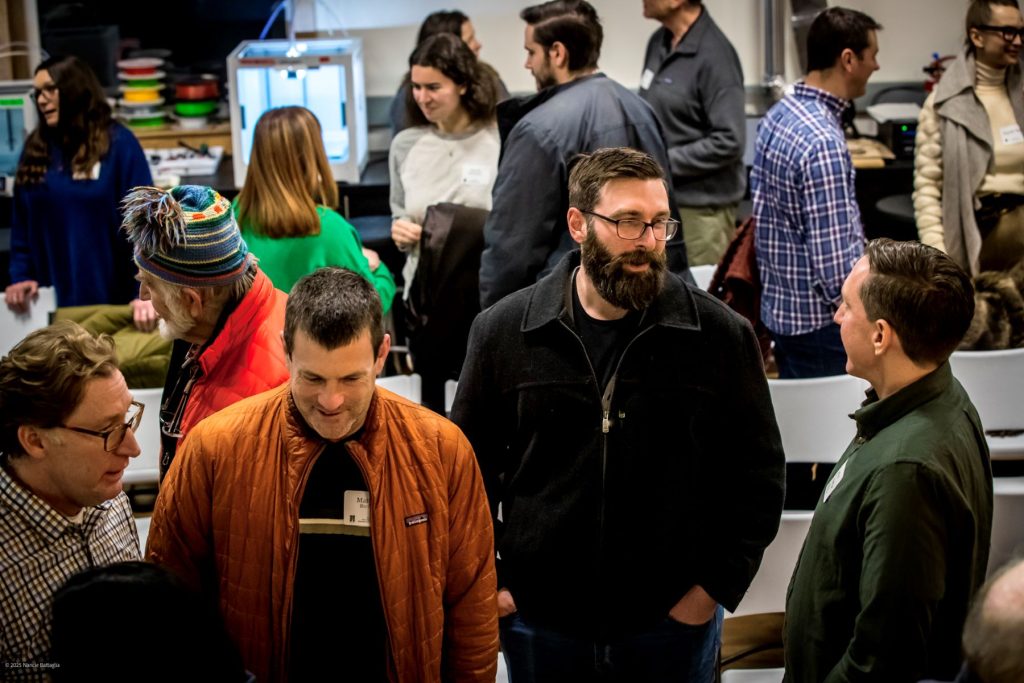 a gathering of people standing and conversing