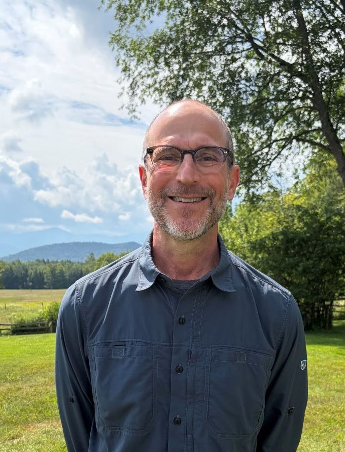 man posing in front of mountain view