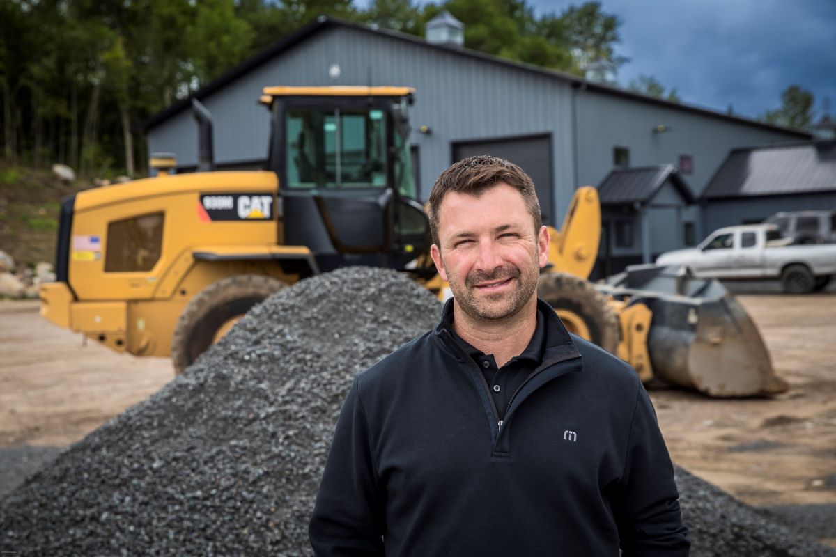 man in front of excavation equipment